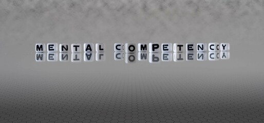 mental competency word or concept represented by black and white letter cubes on a grey horizon...