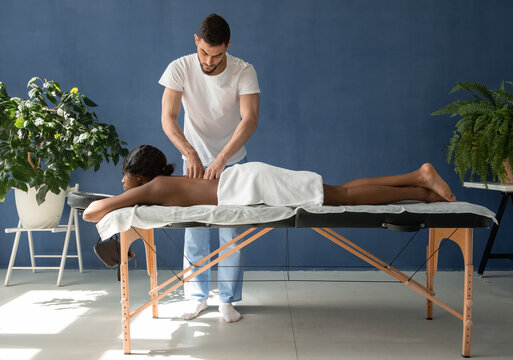 Masseur doing back massage with knuckles
