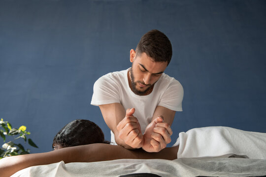 Bearded man doing massage with forearms