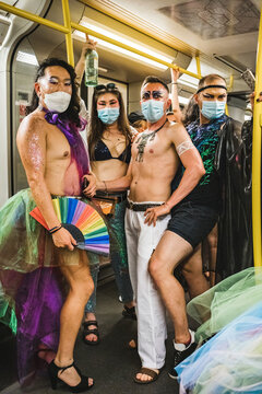 Four friends in subway going to Pride