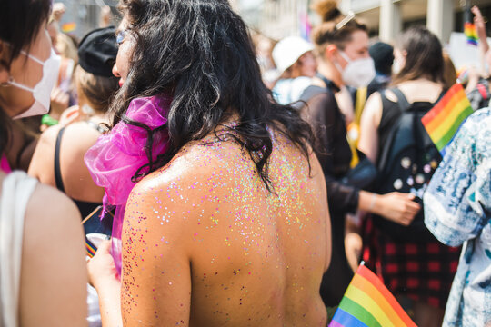 Glittered back of a man at Pride parade