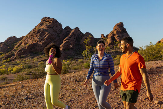 Southwest Desert Landscape with Gen z friends Hiking and laughing 