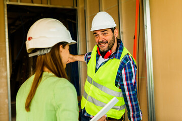 Architect and foreman meeting at construction site,Architect inspects the construction site,Construction project concept.