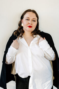 Self assured woman in classy outfit looking at camera