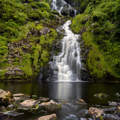 view of the picturesque Assaranca Waterfall on the coast of County Donegal in Ireland