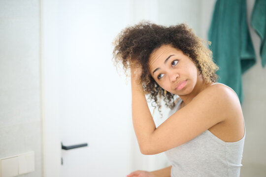 Woman touching hair in morning
