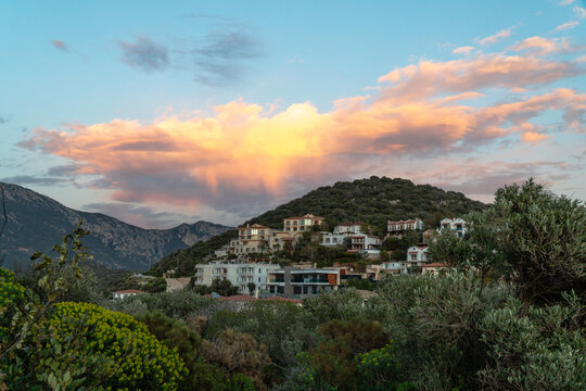 Houses on hillside at sunset
