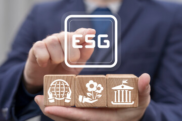 Concept of ESG Environmental Social and Governance. Ecologist using virtual touchscreen and wooden cubes represents banner: ESG.