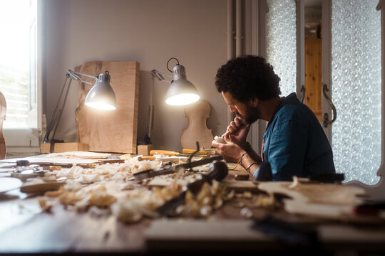 Young carpenter working at his workshop 