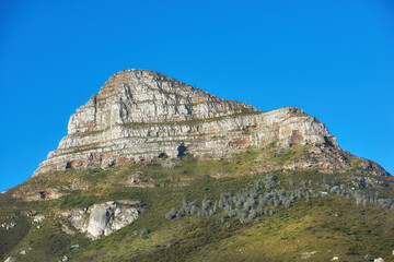 Beautiful Lions Head mountain on clear blue sky with copy space. Summer landscape of mountains with hills covered in green grass or bushes at a tourism sightseeing location in Cape Town, South Africa