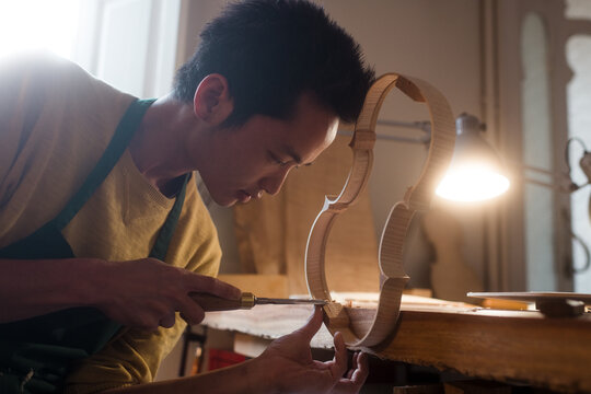 Japanesse luthier creating a violin
