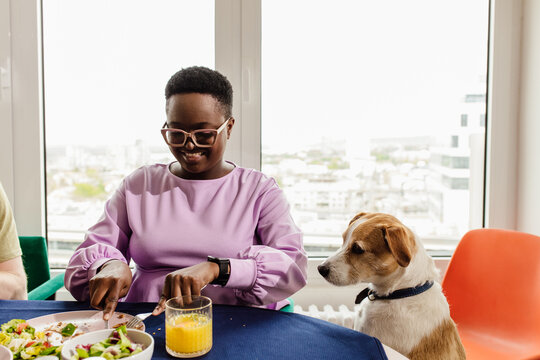 Woman and her dog eating