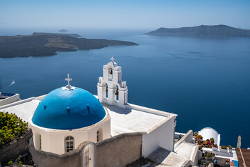 The famous church know as Three Bells of Fira, one of the most iconic landmarks of Santorini, Greece - obrazy, fototapety, plakaty