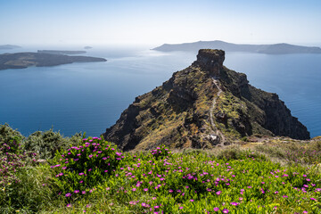 View of Skaros rock, a rocky headland that protrudes out to the azure blue Aegean Sea, Imerovigli, Santorini, Greece - obrazy, fototapety, plakaty