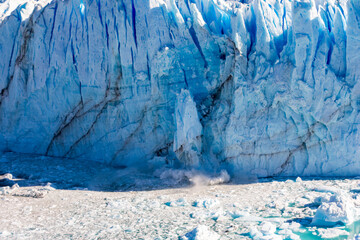 A piece of the Perito Moreno glacier breaks off and falls in to the lake below. The Perito Moreno glacier is located in the Los Glaciares National Park in the Patagonia region of Argentina.