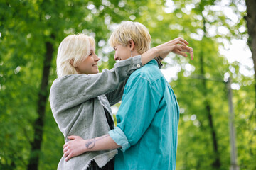 Lesbian couple having romantic walk in spring forest 