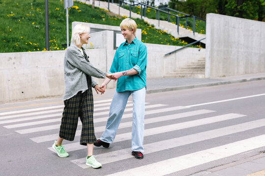 Lovely couple admiring to each other and walking on pedestrian 
