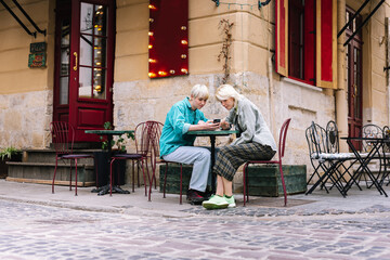 Girls using online application to selecting meal in restaurant 