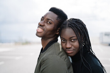 Happy loving black couple hugging in city