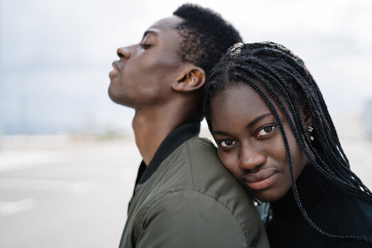 Beloved black lady hugging peaceful boyfriend