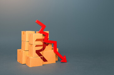 Boxes with indian rupee symbol and down arrow. Decrease in stocks of products. The fall in the...