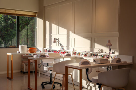 Minimalist, bright beauty salon design with equipped workstations