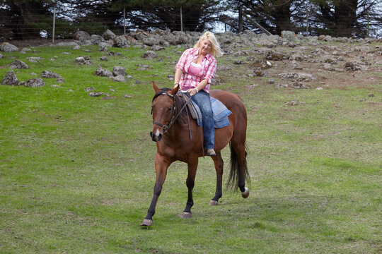 Woman riding horse bareback