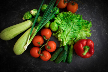 Fresh different vegetables on dark background