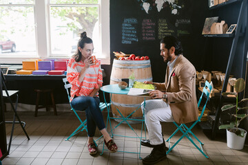 Couple happily enjoying coffee in coffee shop