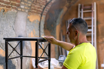 master carpenter preparing a table to restore