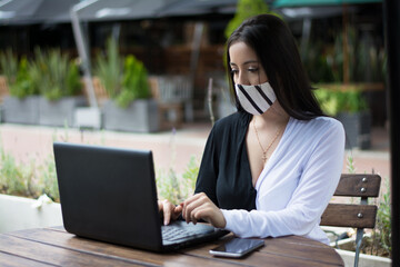 Young woman working outdoor wearing mask