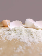 Halved egg shells with flour laying on baking paper