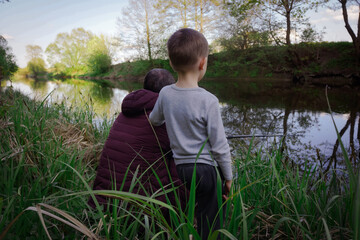 Father and son fishing on the bank of the river