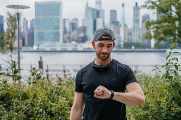 Young Adult Male Setting Watch to Record Workout