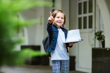 little girl,schoolgirl,in school uniform,in the school yard