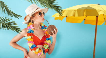 Woman with swimsuit refreshing with a coconut