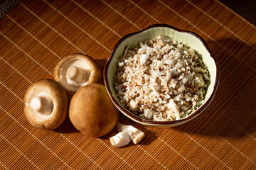 Shiitake and chopped shiitake mushrooms on a vintage background