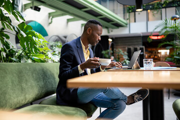 Businessman Working In Cafeteria