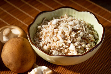 Shiitake and chopped shiitake mushrooms on a vintage background
