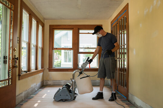 Man pushing drum sander