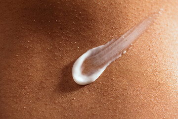 Stroke of cream on skin with goosebumps