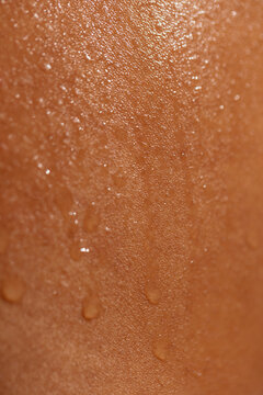 Drops of sweat on brown skin
