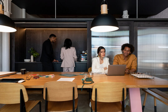 Diverse coworkers speaking in workplace