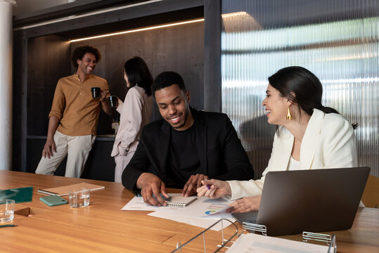 Diverse employees working and taking break in office