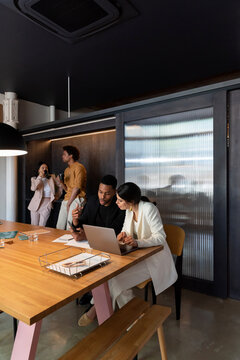 Diverse employees working and taking break in office