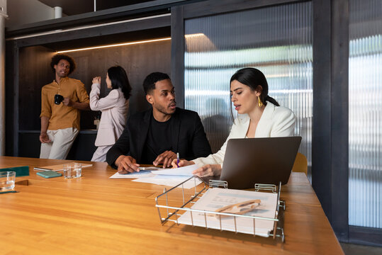 Diverse employees working and taking break in office