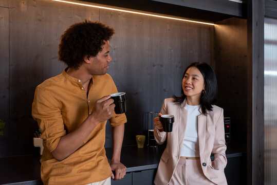 Cheerful diverse coworkers having coffee break