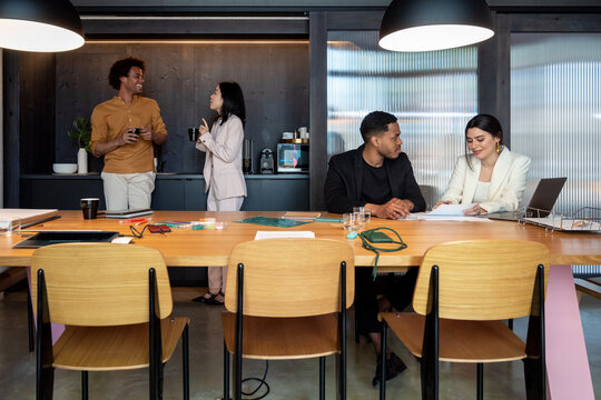 Diverse employees working and taking break in office