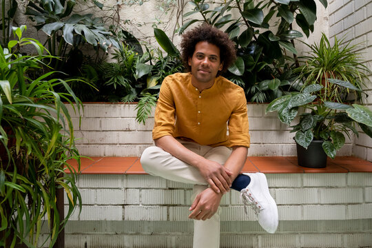 Relaxed black employee in indoor garden