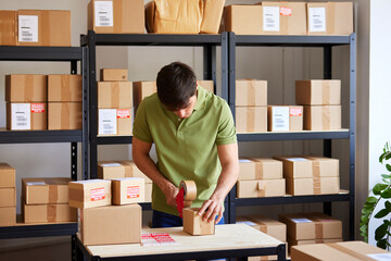 Logistic manager sealing parcel during work